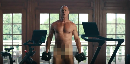 Christopher Meloni doing bicep curls for a Peloton ad