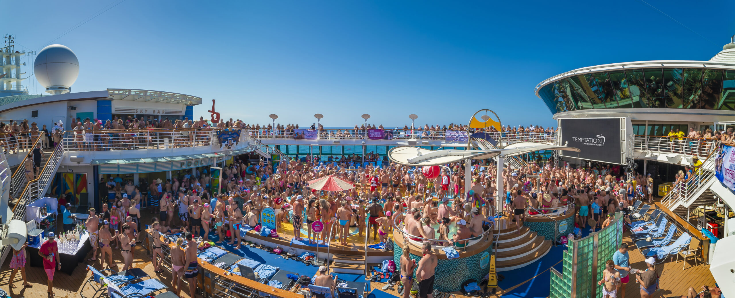 Crowd in swimwear in sun on board ship