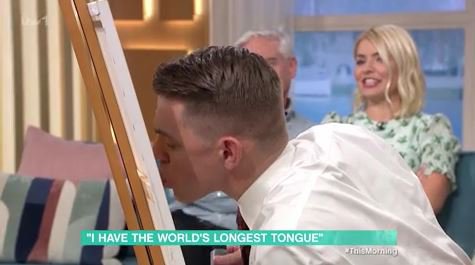 Grabs: This Morning Man with world's longest tongue uses record breaking body part to paint Holly and Phil in wild This Morning interview ITV