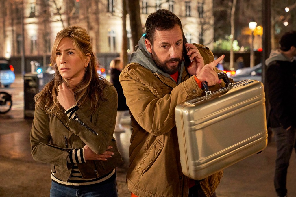 This image released by Netflix shows Jennifer Aniston, left, and Adam Sandler in a scene from the film 