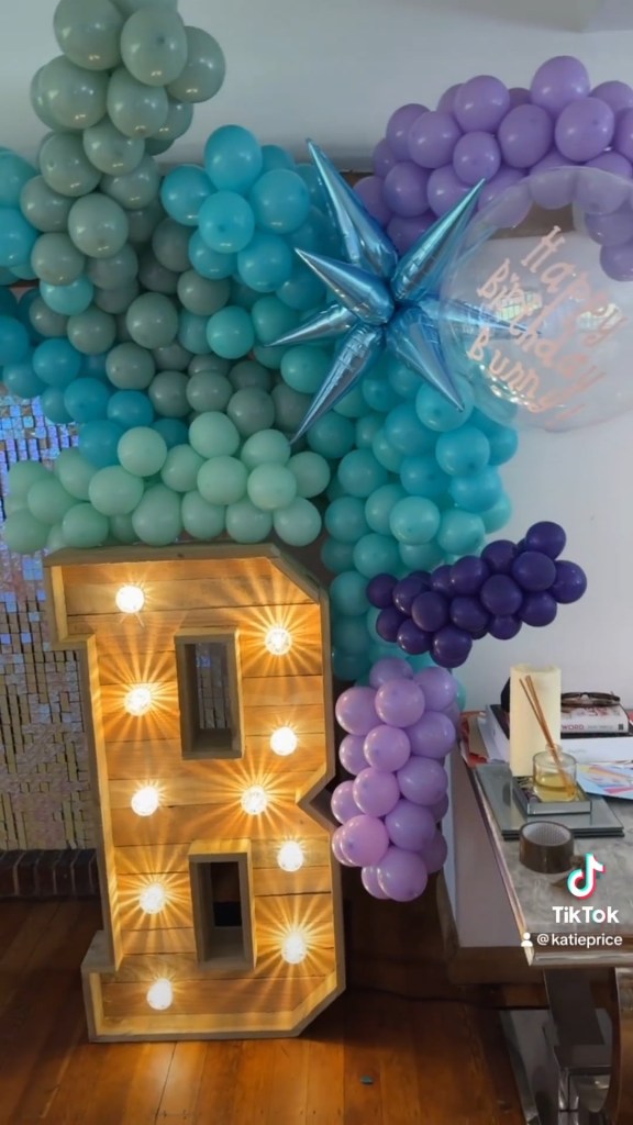 Grab from video posted to Instagram by Katie Price. Captioned @katieprice. Bunny?s reaction at the end . we transformed my living room into a mermaid themed party in just ONE HOUR for Bunny?s 9th Birthday today. Huge thank you to: Mermaid bed bunks @bestiebunks Balloons, Light & Sequin wall @bohemianightsevents Food @Lazeegraze Cake @ellesbellsbakes Cookies&cakesicles @faye.marie.cakery # gifted https://www.instagram.com/p/CvkZaLOrwxP/