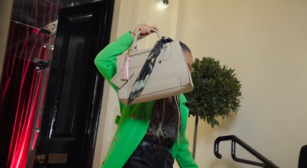 A person conceals their face with a handbag in the teaser for Celebrity Big Brother
