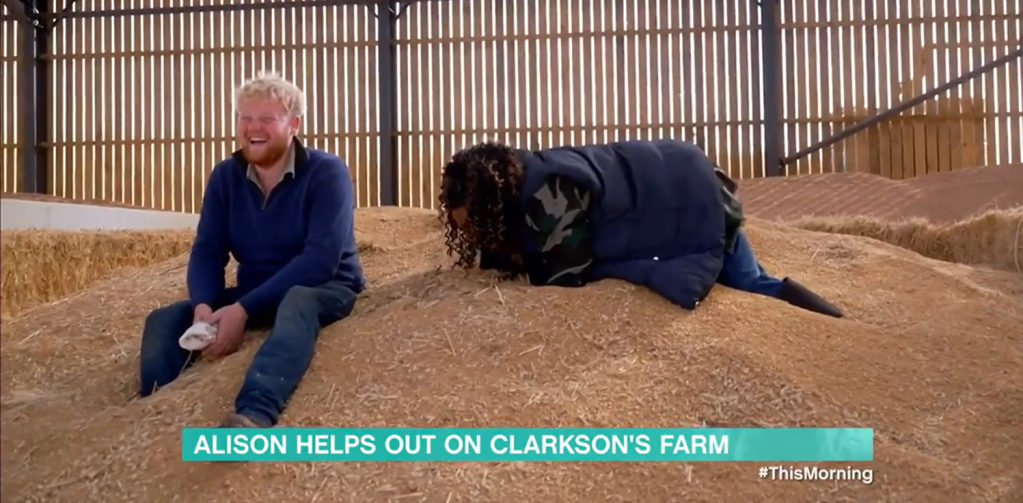 Alison Hammond and Kaleb Cooper on a pile of hay