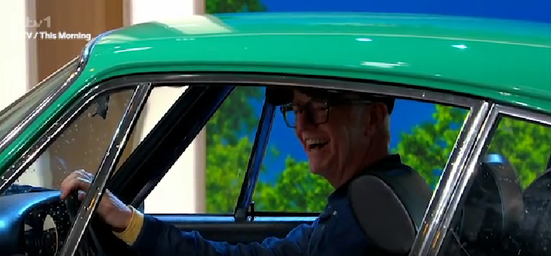 Chris Evans on This Morning in a green car, smiling