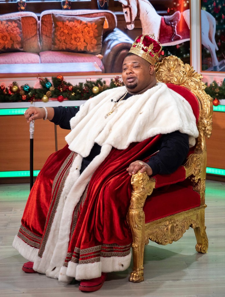 Big Narstie sat on throne wearing crown and cape